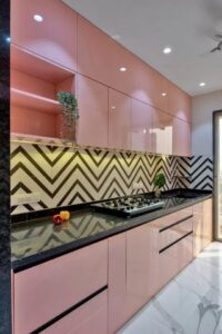 rose pink kitchen interior with black counter top