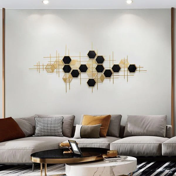 Statement wall art behind a grey modern sofa in a stylish living room, adding a sophisticated and elegant touch