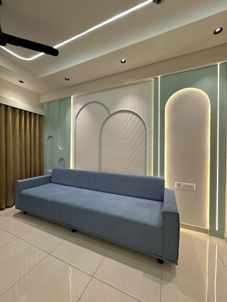 Stylish wall molding with a blue sofa and beige curtains in a modern living room interior design