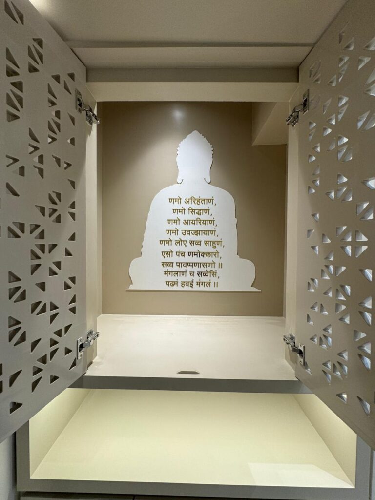 Modern mandir design in Ahmedabad with elegant lighting and carved panel doors