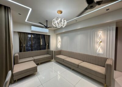 Modern living room interior with linear sofa seating, wall paneling, and POP ceiling lighting
