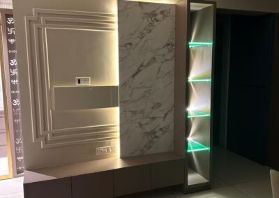 Decorative feature wall with marble finish panel, open display shelves, and base tv unit