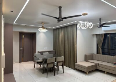 Dining and living space with chandelier, ceiling fan, sofa seating, and ambient ceiling lighting