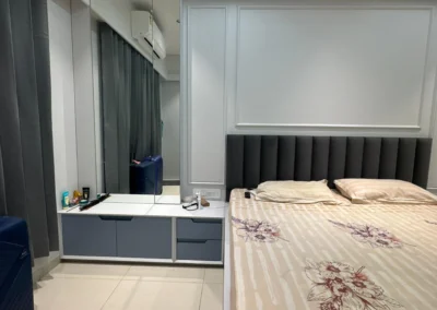 Bedroom interior with storage bed, compact study desk, TV unit, and POP ceiling with soft lighting