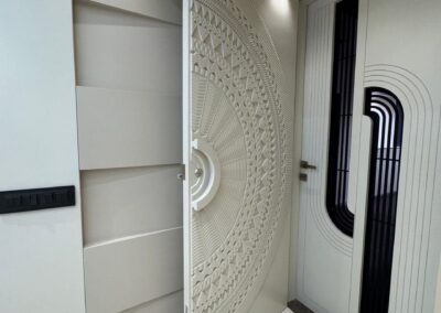 Main entrance door with mandala CNC wall design and concealed electrical DB unit integrated into the panel by J Designs