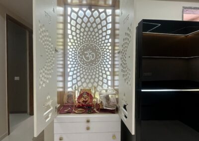 Home mandir unit with CNC cut back panel, drawer storage, and warm ambient lighting designed by J Designs