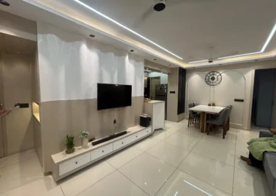 Modern living room interior with wall-mounted TV unit, glossy flooring, and clean layout by J Designs